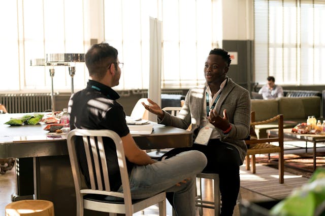 Two people sitting across from eachother at a table